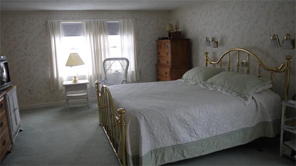 5 Rowell Road Danvers, MA 01923 - Photo 21 of 26 a bedroom with a bed next to a window and mirror
