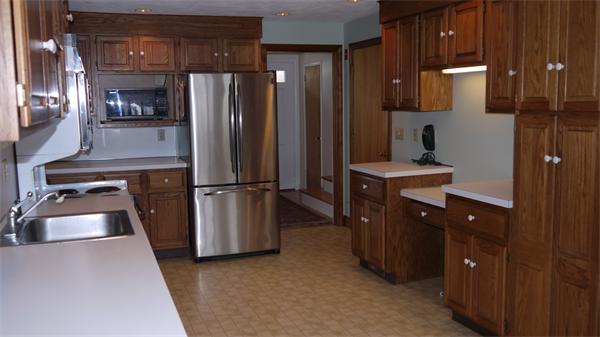 5 Rowell Road Danvers, MA 01923 - Photo 5 of 26 a kitchen with refrigerator and cabinets