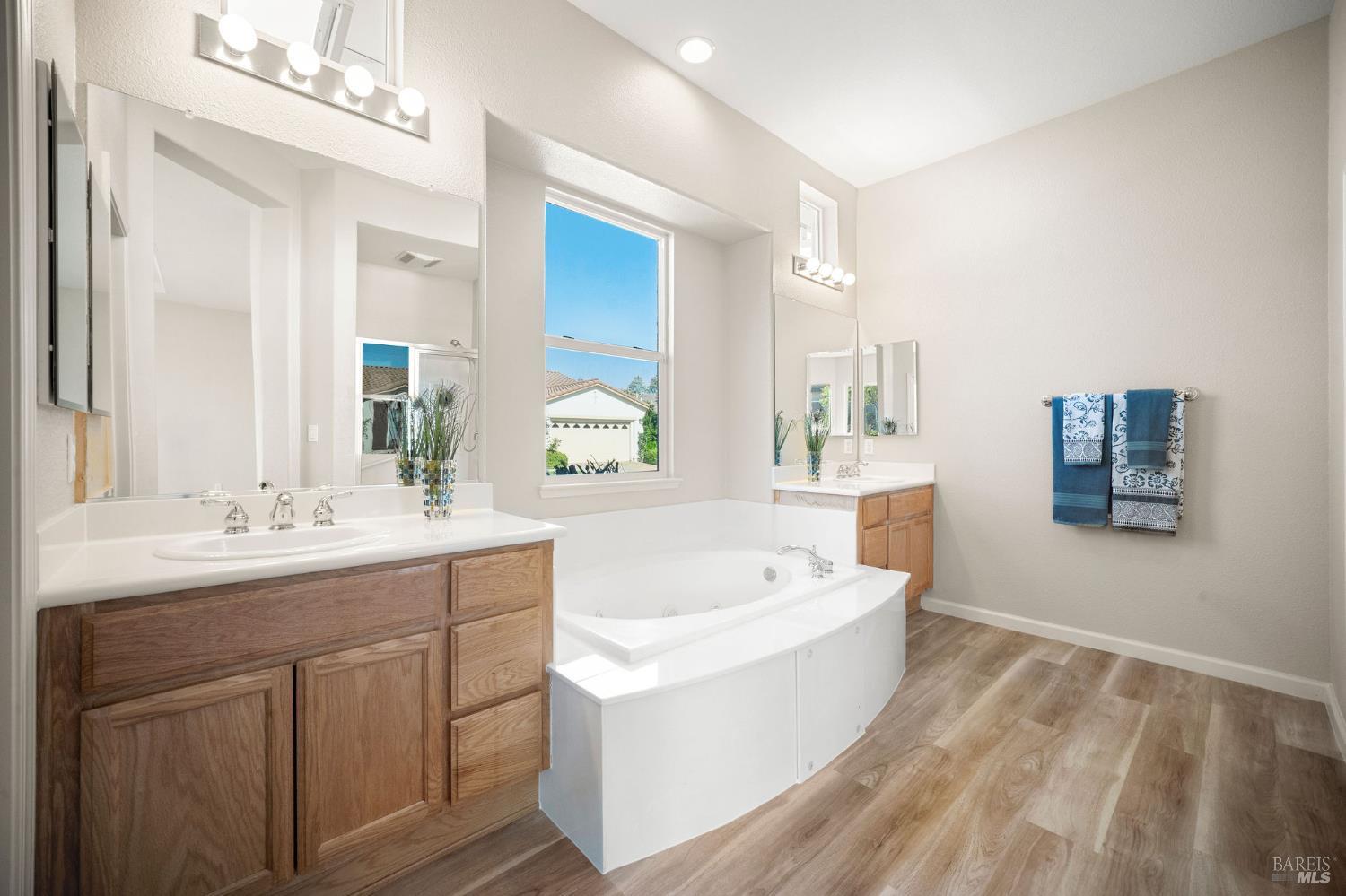 377 Shadow Creek Drive Rio Vista, CA 94571 - Photo 21 of 77 primary bathroom with double sinks, soaking tub, and new LVP flooring