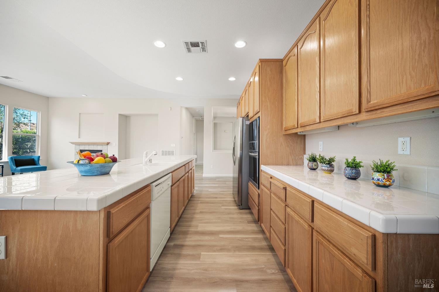 377 Shadow Creek Drive Rio Vista, CA 94571 - Photo 10 of 77 kitchen with oak cabinets, tile counters, and LVP flooring