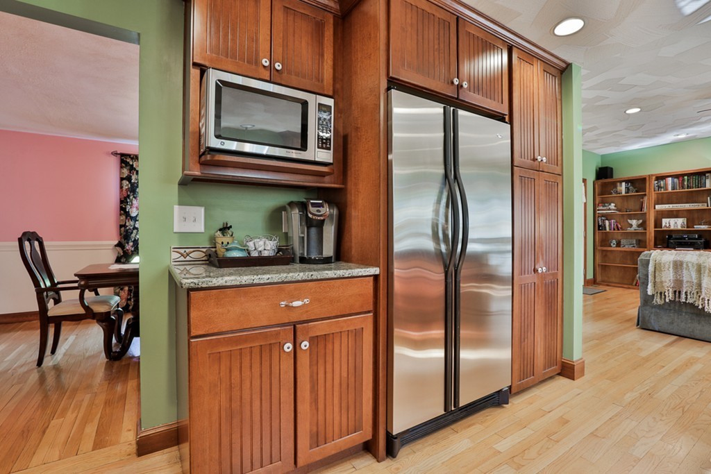 14 Belmont Road Billerica, MA 01821 - Photo 16 of 30 a kitchen with stainless steel appliances granite countertop a refrigerator a stove and a microwave with wooden floor