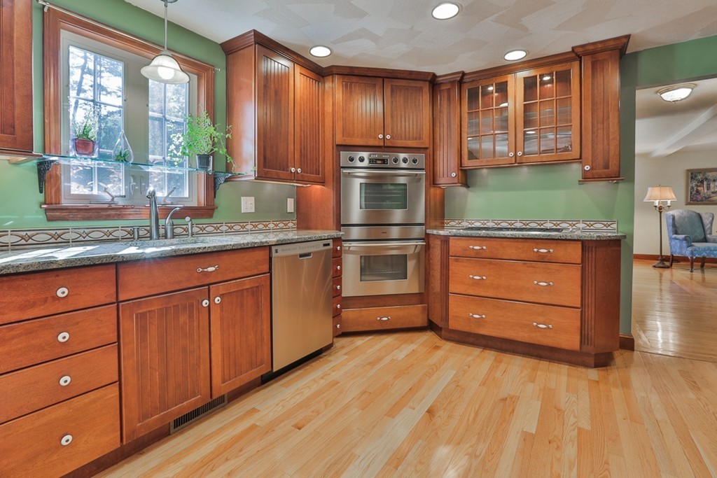 14 Belmont Road Billerica, MA 01821 - Photo 18 of 30 a kitchen with stainless steel appliances granite countertop a stove and a wooden cabinets