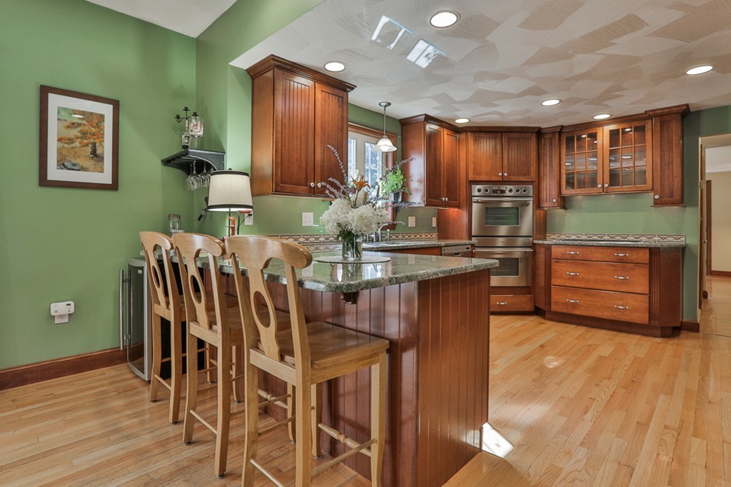 14 Belmont Road Billerica, MA 01821 - Photo 19 of 30 a kitchen with stainless steel appliances kitchen island granite countertop a table chairs and a refrigerator