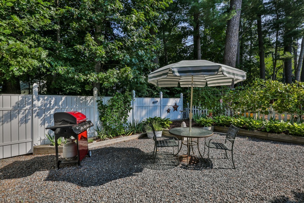 14 Belmont Road Billerica, MA 01821 - Photo 8 of 30 a view of a table and chairs under an umbrella