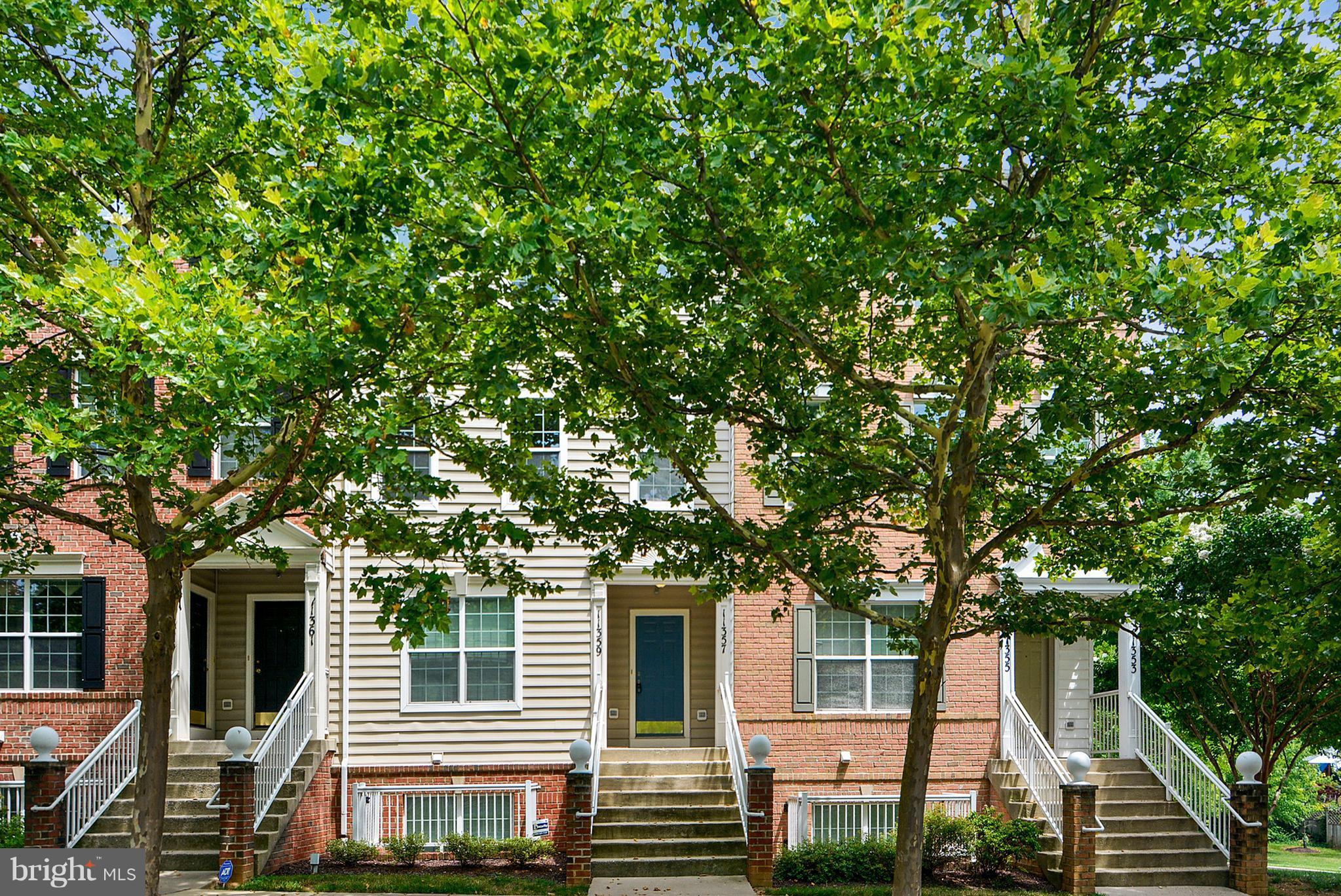 11357 King George Drive, Unit 10 Wheaton, MD 20902 - Photo 2 of 30 a front view of a house with a tree