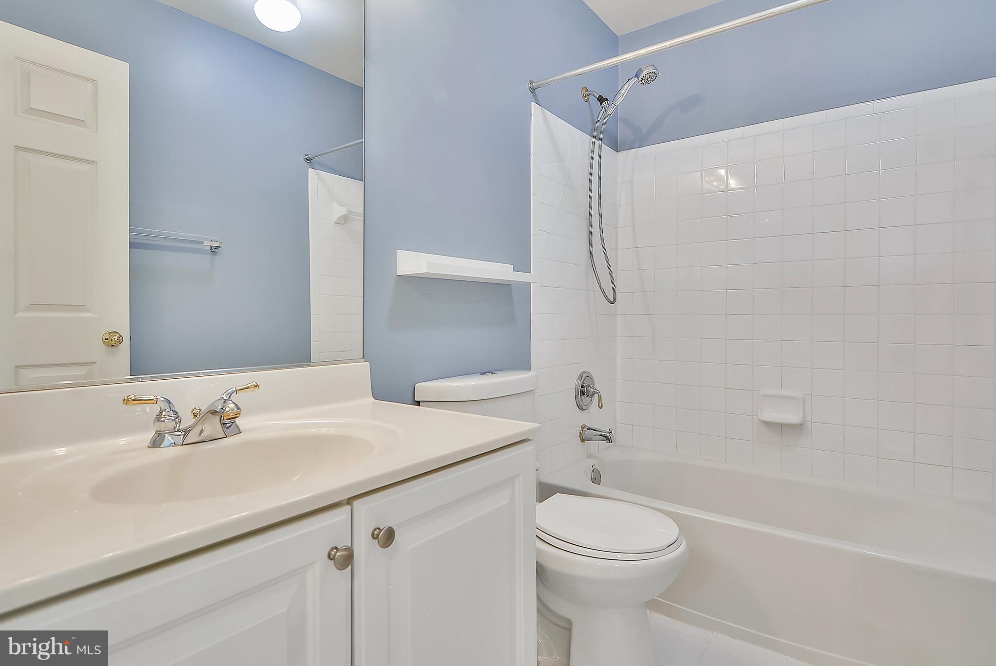 11357 King George Drive, Unit 10 Wheaton, MD 20902 - Photo 16 of 30 a bathroom with a sink a toilet and shower