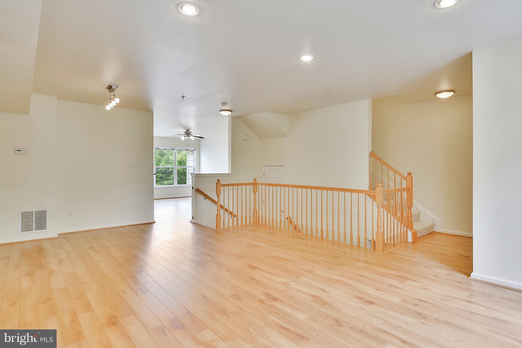 11357 King George Drive, Unit 10 Wheaton, MD 20902 - Photo 3 of 30 a view of an empty room with wooden floor