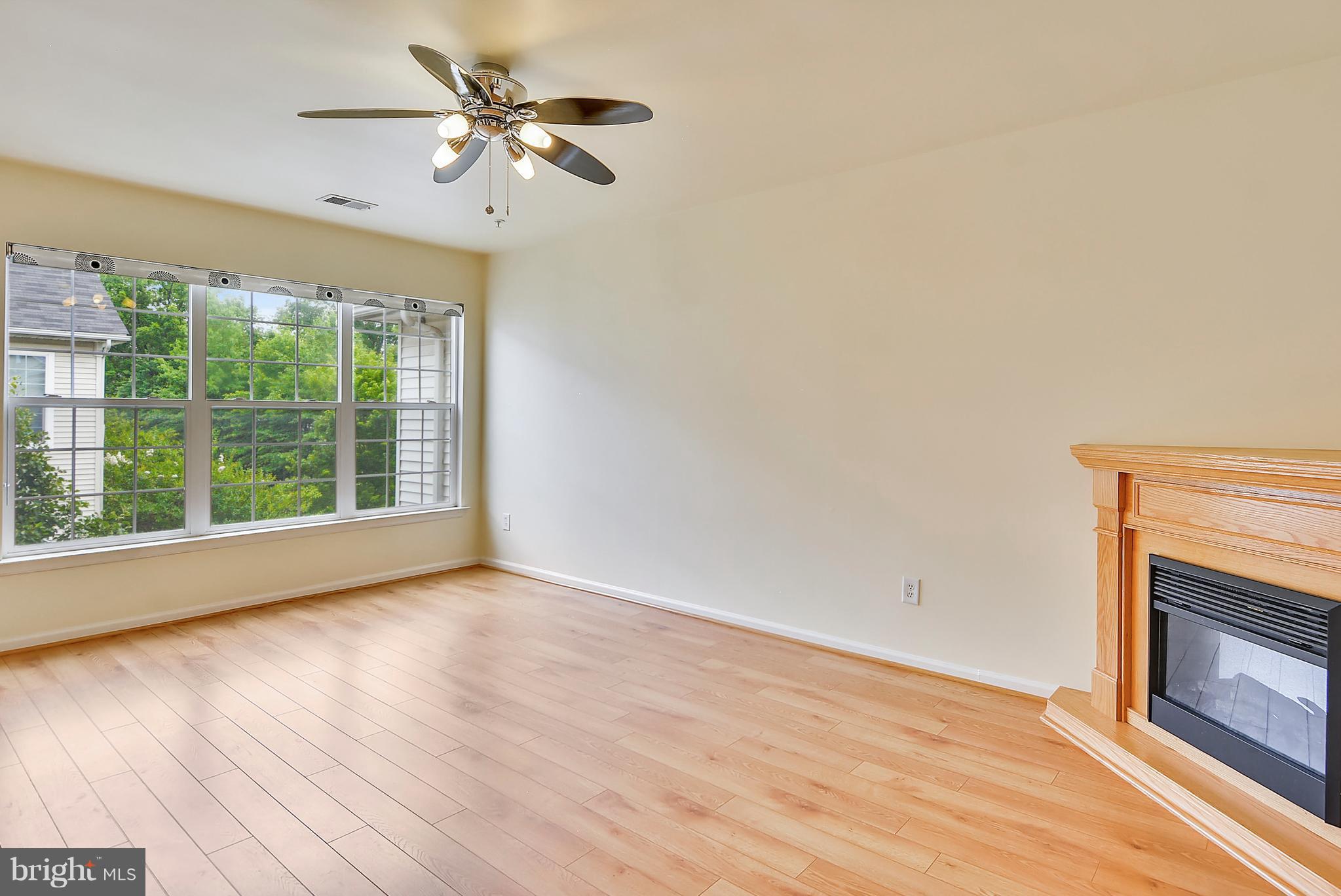 11357 King George Drive, Unit 10 Wheaton, MD 20902 - Photo 7 of 30 a view of empty room with wooden floor and fan