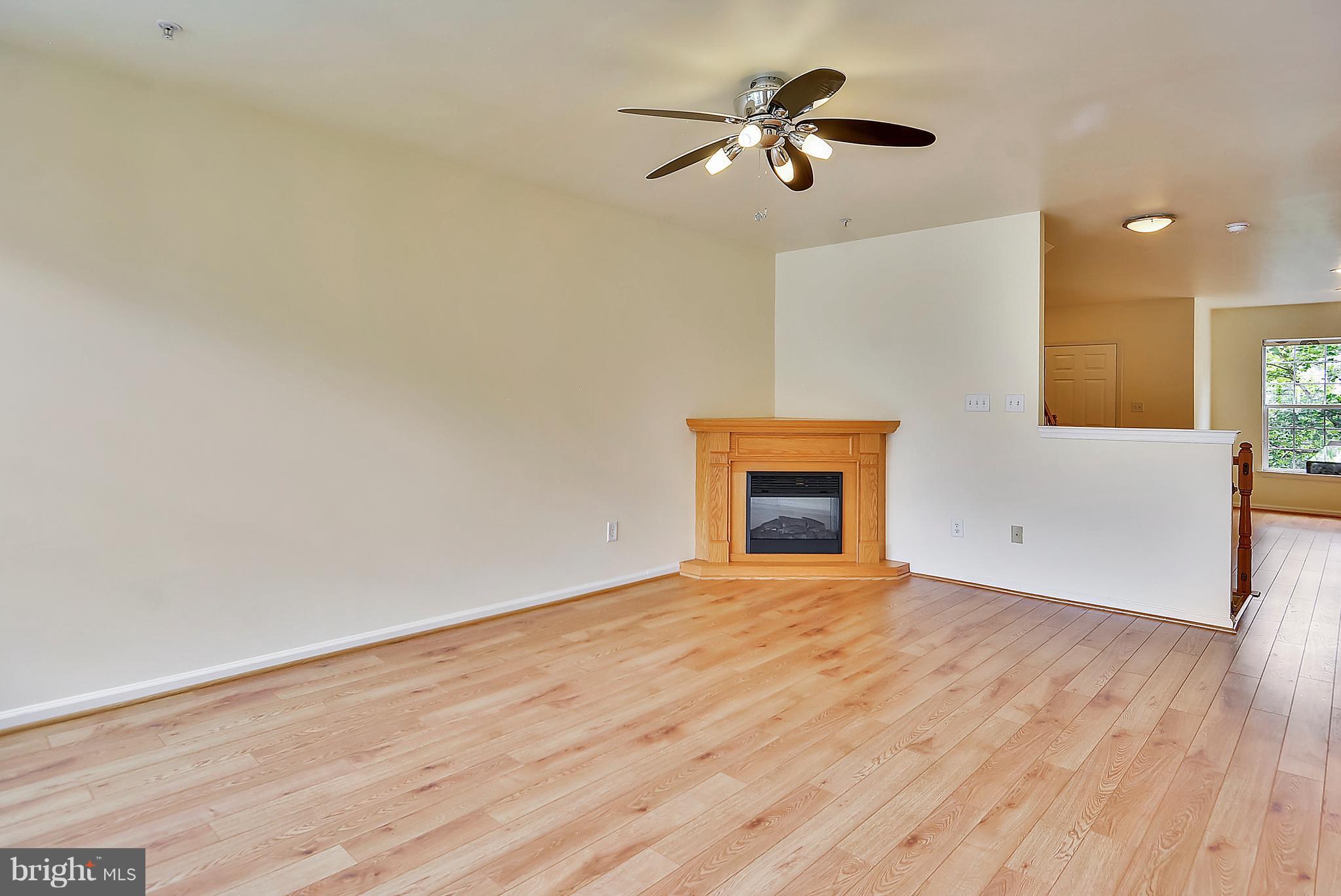 11357 King George Drive, Unit 10 Wheaton, MD 20902 - Photo 8 of 30 wooden floor in an empty room with a fireplace