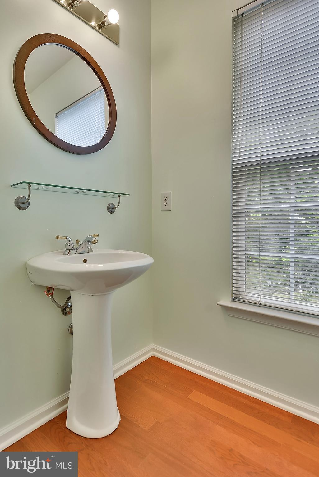11357 King George Drive, Unit 10 Wheaton, MD 20902 - Photo 9 of 30 a bathroom with a sink a mirror and a window