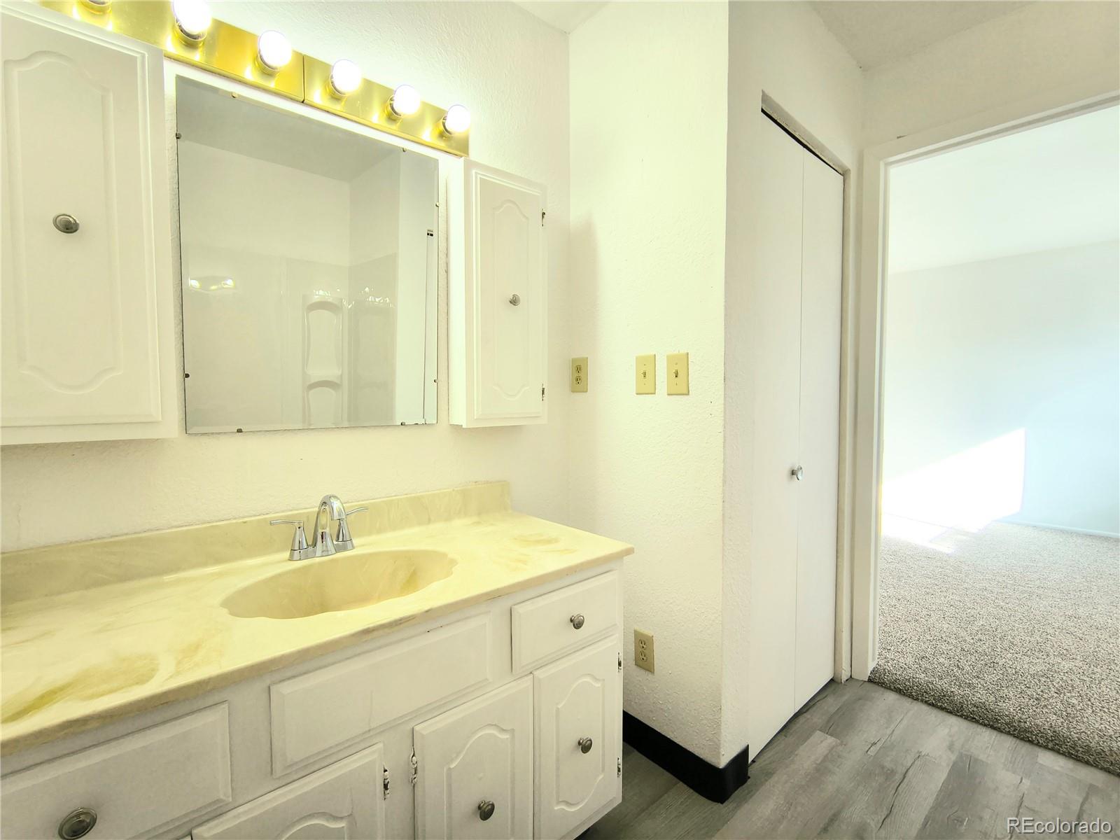 3279 County Rd CC252 Colorado City, CO 81019 - Photo 11 of 22 a bathroom with a sink a mirror and a shower