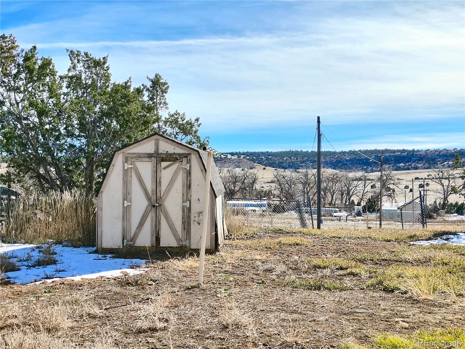 3279 County Rd CC252 Colorado City, CO 81019 - Photo 17 of 22 a view of a dry yard with wooden fence