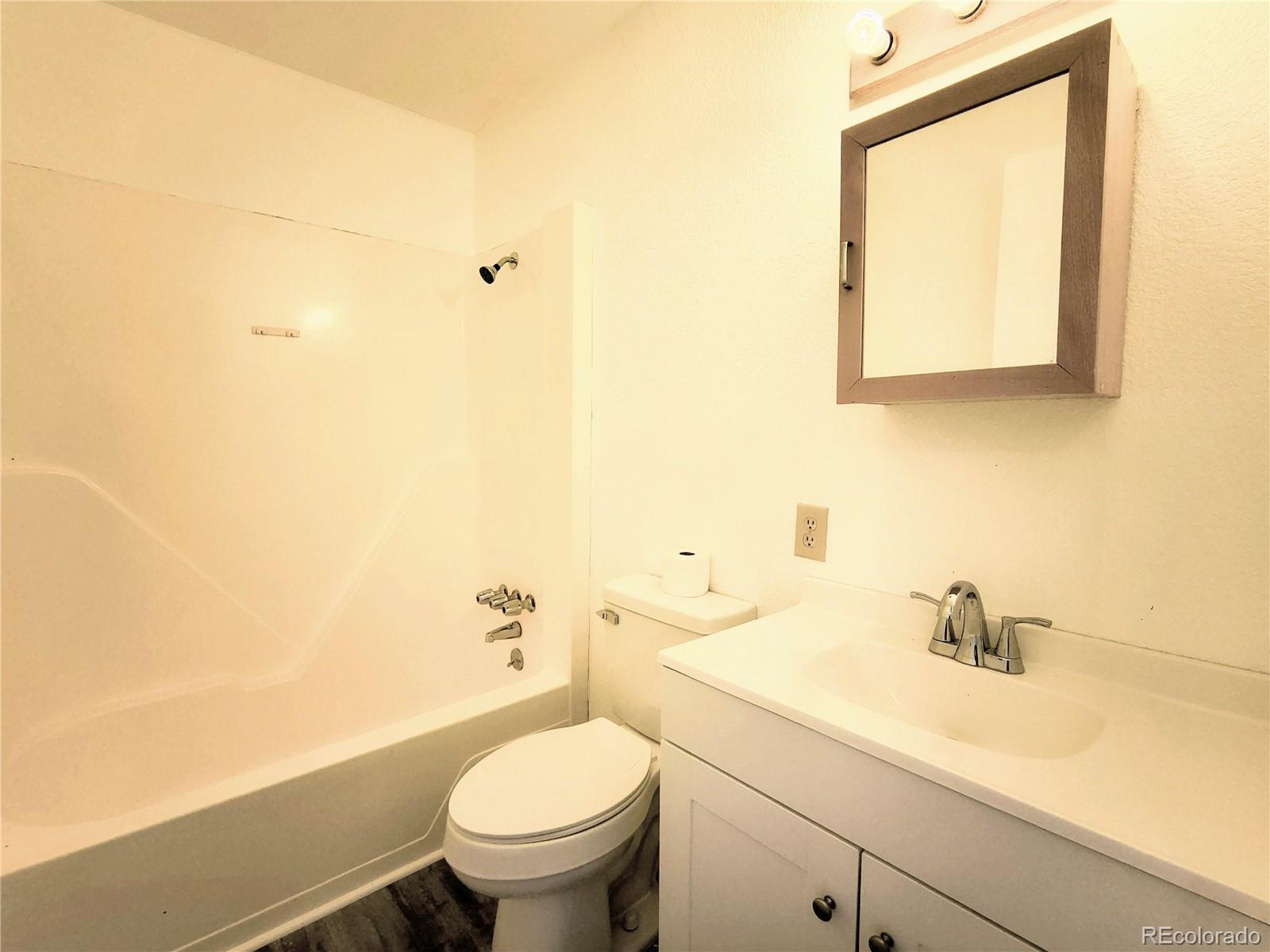 3279 County Rd CC252 Colorado City, CO 81019 - Photo 6 of 22 a bathroom with a sink a toilet and mirror