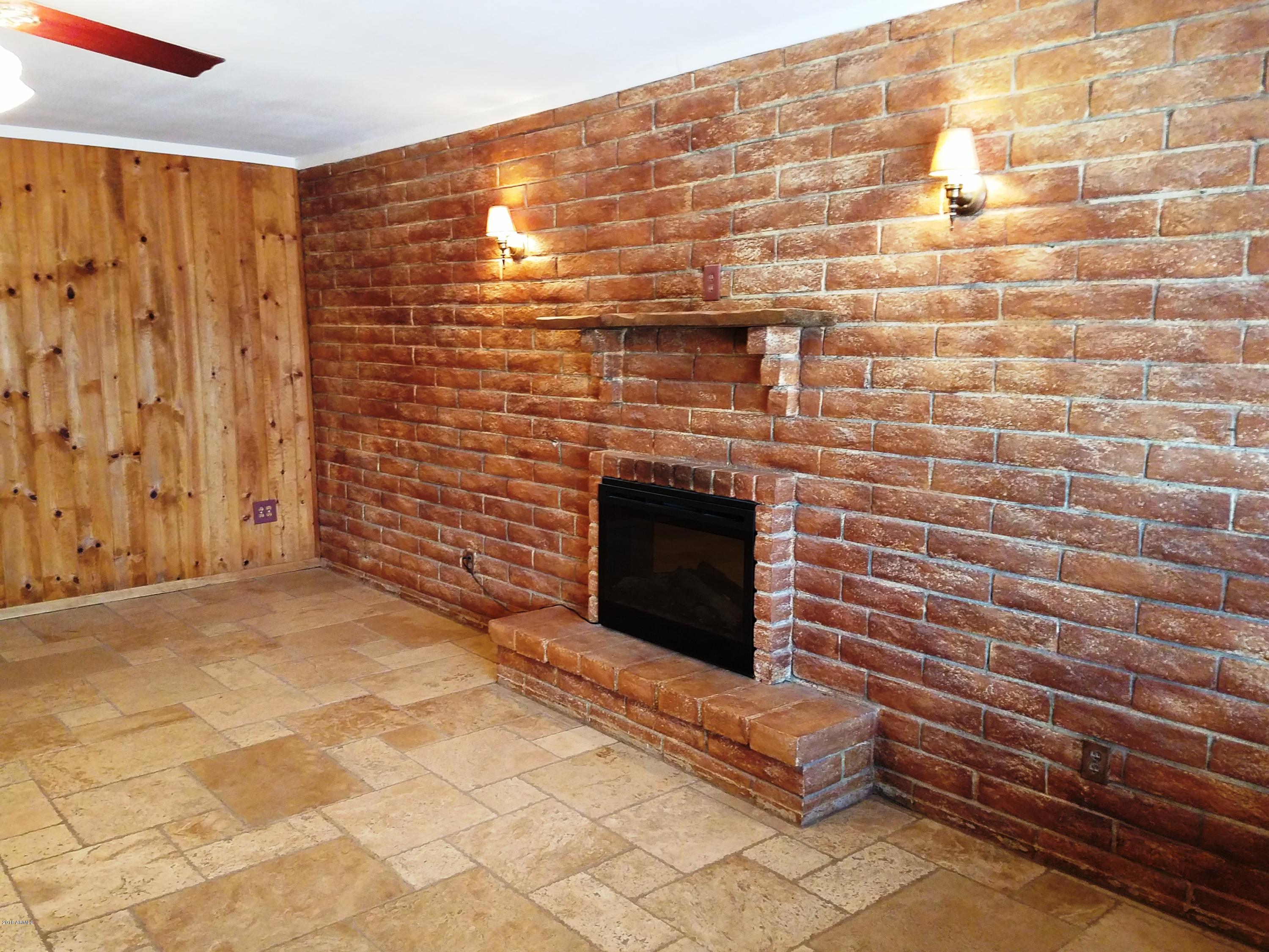 1002 East Maddock Road Phoenix, AZ 85086 - Photo 9 of 49 Maddock - fireplace and brick wall