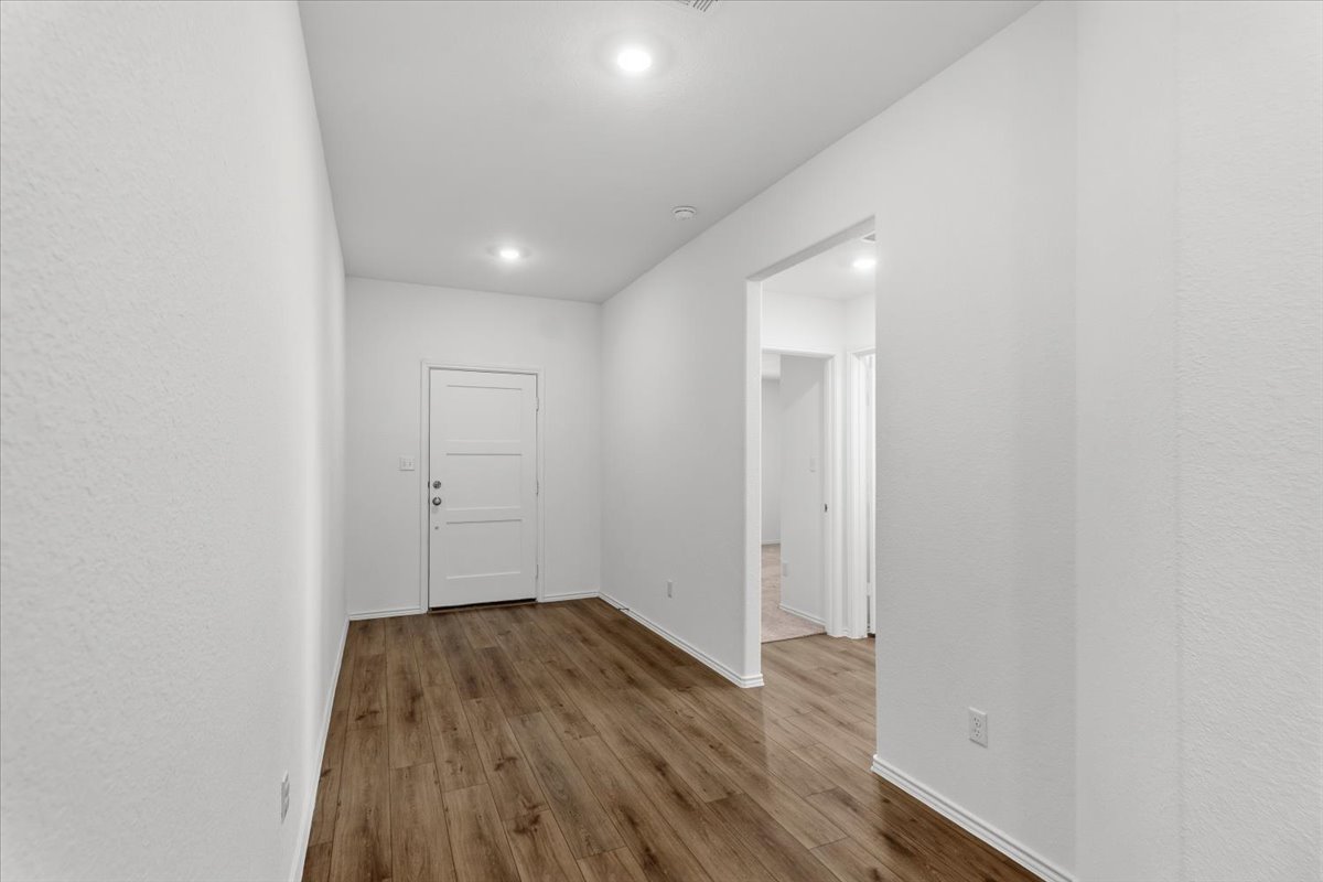 167 Jeffers Kyle, TX 78640 - Photo 10 of 40 a view of a room with wooden floor and white walls