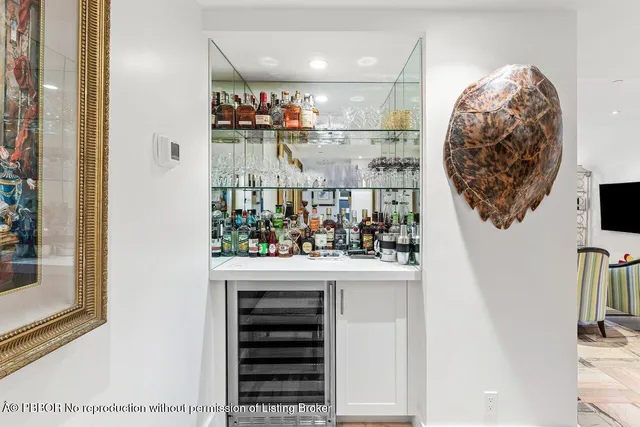 a large white kitchen with stainless steel appliances and a stove