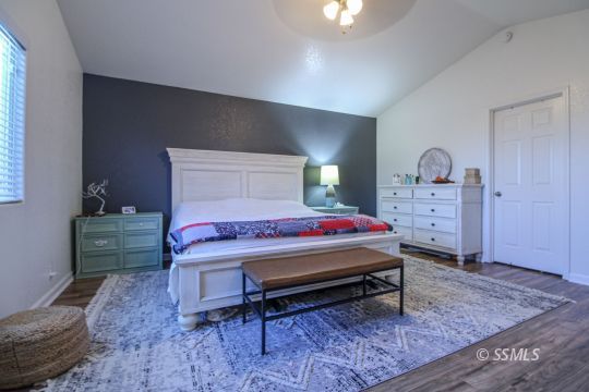 1000 West Iowa Avenue Ridgecrest, CA 93555 - Photo 12 of 32 a bedroom with a bed and a dresser in it