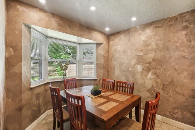 a view of a dining room with furniture window and outside view