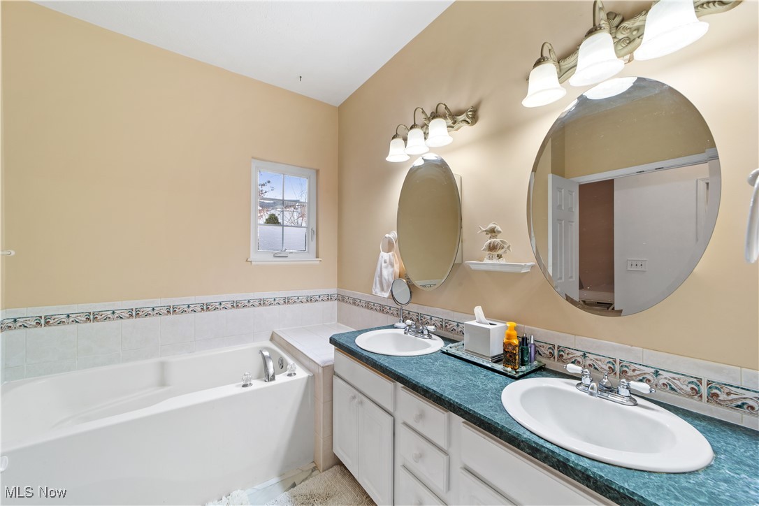 4461 Sexton Road Cleveland, OH 44105 - Photo 17 of 47 Primary bathroom with double vanity and a bath