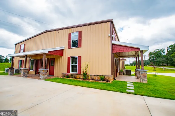 a front view of house with yard and outdoor seating