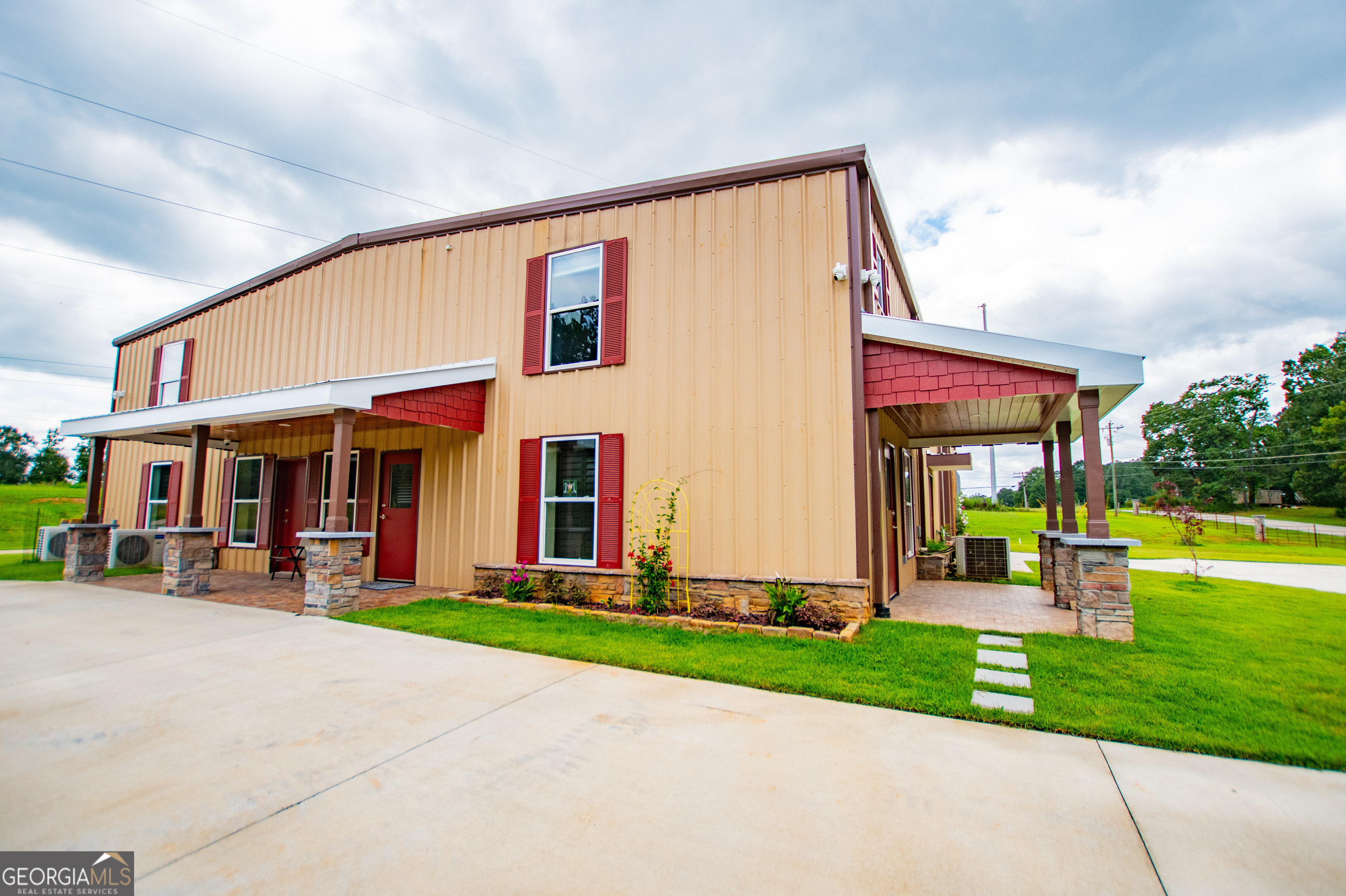 a front view of house with yard and outdoor seating