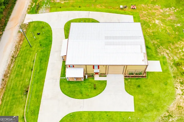 a dining room with furniture a chandelier and wooden floor