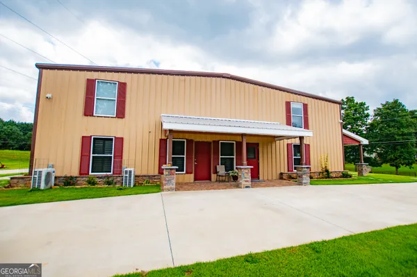 a view of a big building with a big yard and plants
