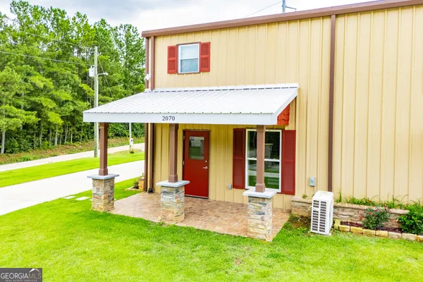 a spacious bedroom with a bed and a chandelier
