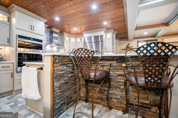 a bathroom with a tub a window and a shower