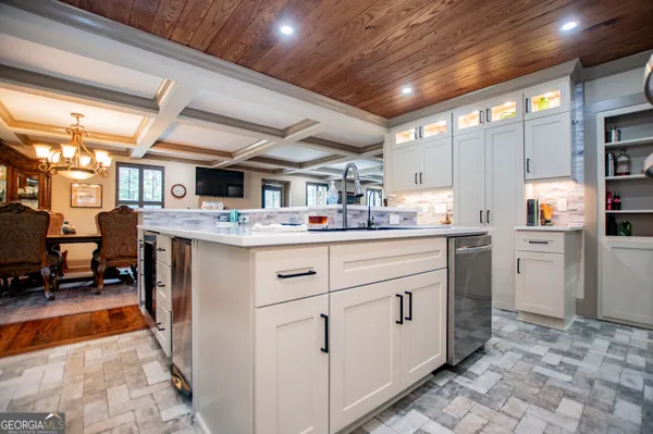 a view of a dining room with furniture and a chandelier