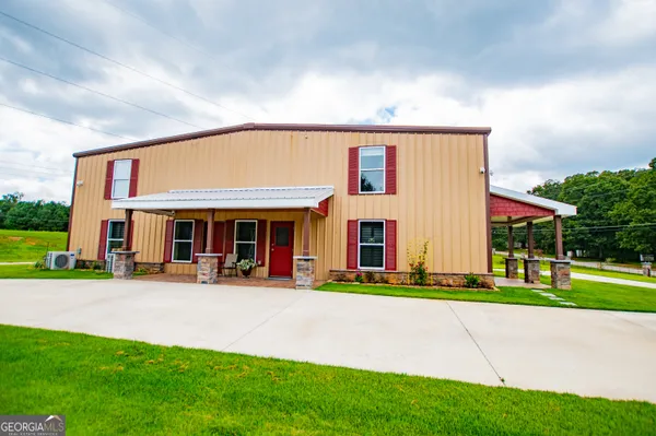 a view of a swimming pool with a table and chairs under an umbrella