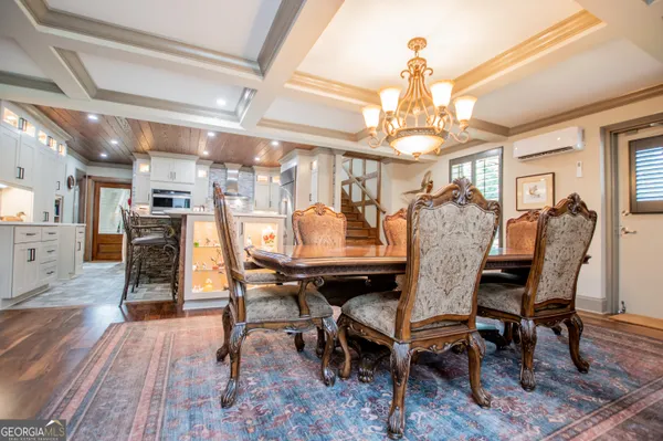 a view of a dining room with furniture kitchen and wooden floor