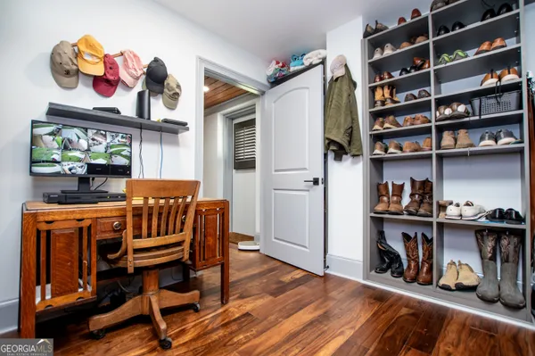 a kitchen with cabinets stainless steel appliances a sink and wooden floor