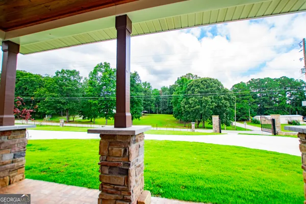 a view of a house with a swimming pool and a yard