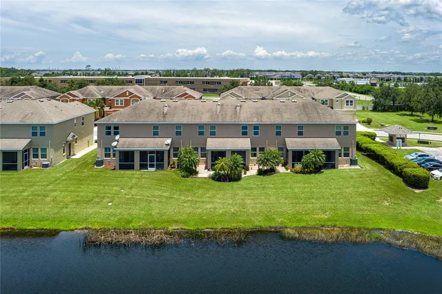 an aerial view of a house with a garden and lake view