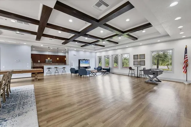 a room with lots of furniture and a flat screen tv