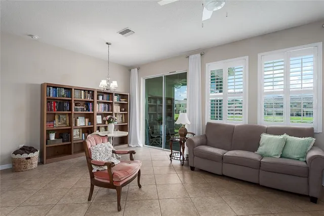 a living room with furniture and a book shelf