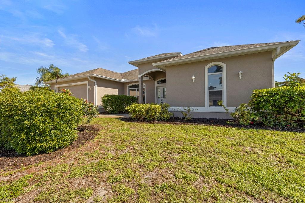 18245 Hemlock Road Fort Myers, FL 33967 - Photo 3 of 25 a front view of house with yard and trees around
