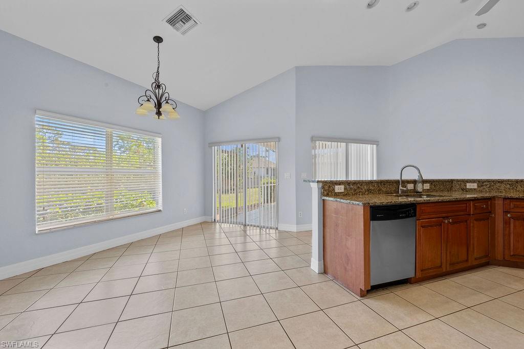 18245 Hemlock Road Fort Myers, FL 33967 - Photo 7 of 25 a kitchen with granite countertop a sink cabinets and window
