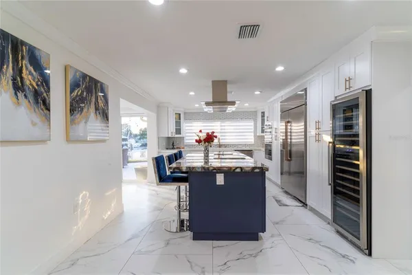 a kitchen with stainless steel appliances kitchen island granite countertop a sink and cabinets