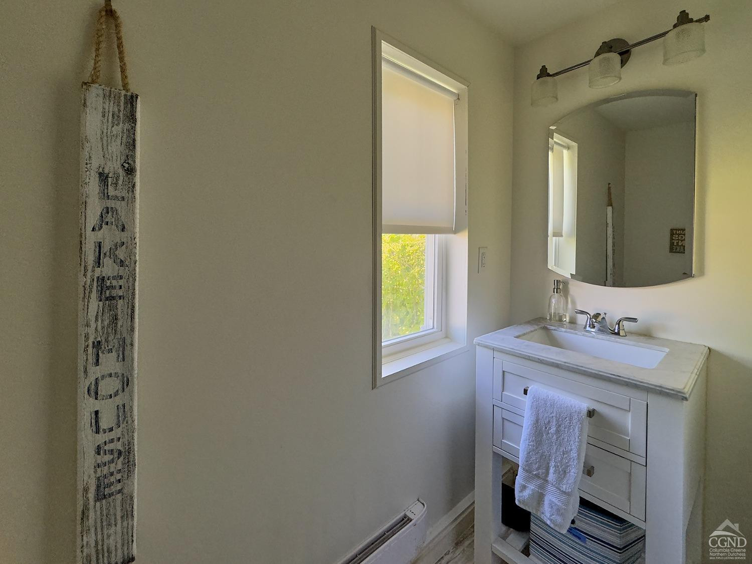 7 Pheasant Road Craryville, NY 12521 - Photo 23 of 26 a bathroom with a sink a toilet and a mirror