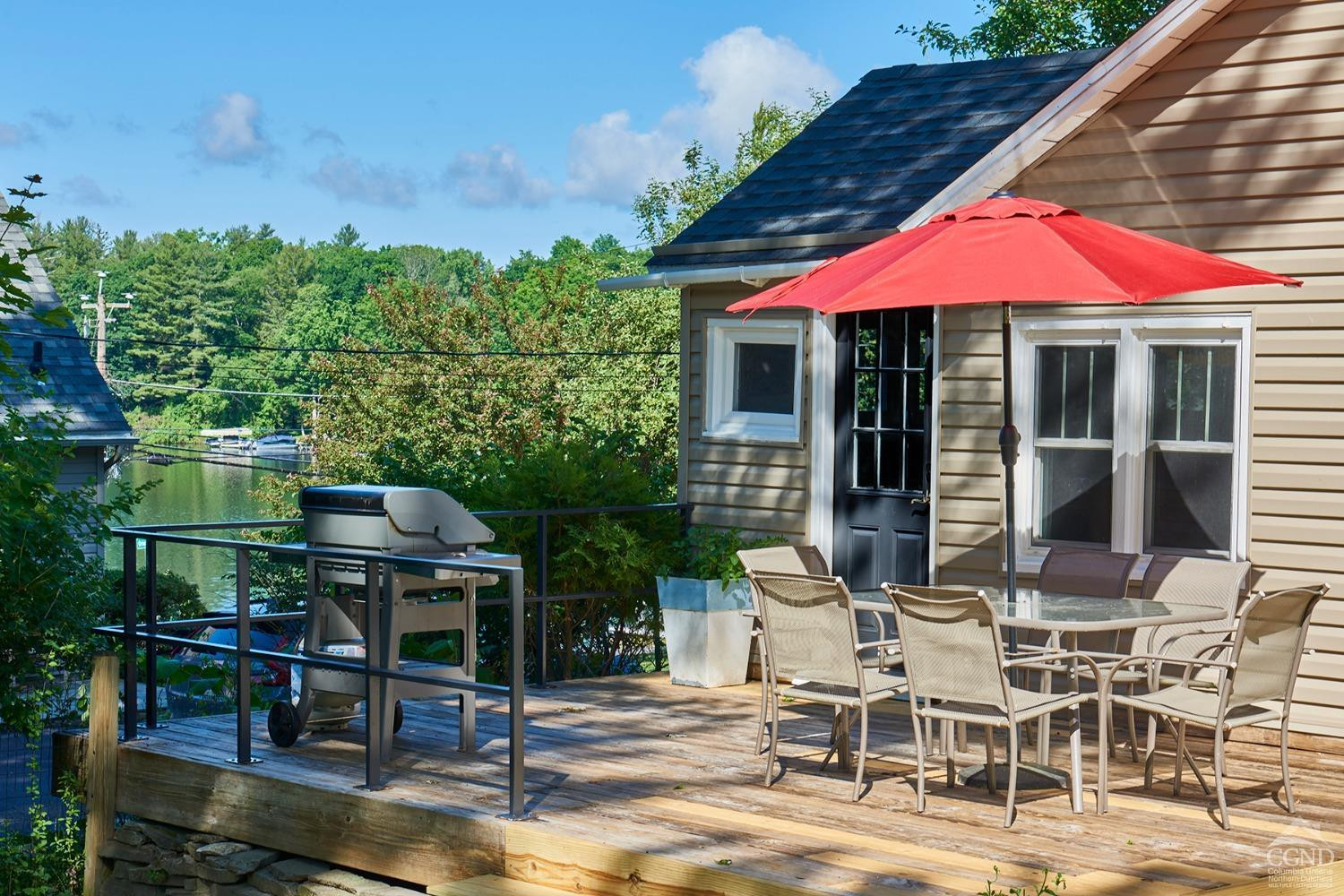 7 Pheasant Road Craryville, NY 12521 - Photo 3 of 26 a patio with a table and chairs under an umbrella