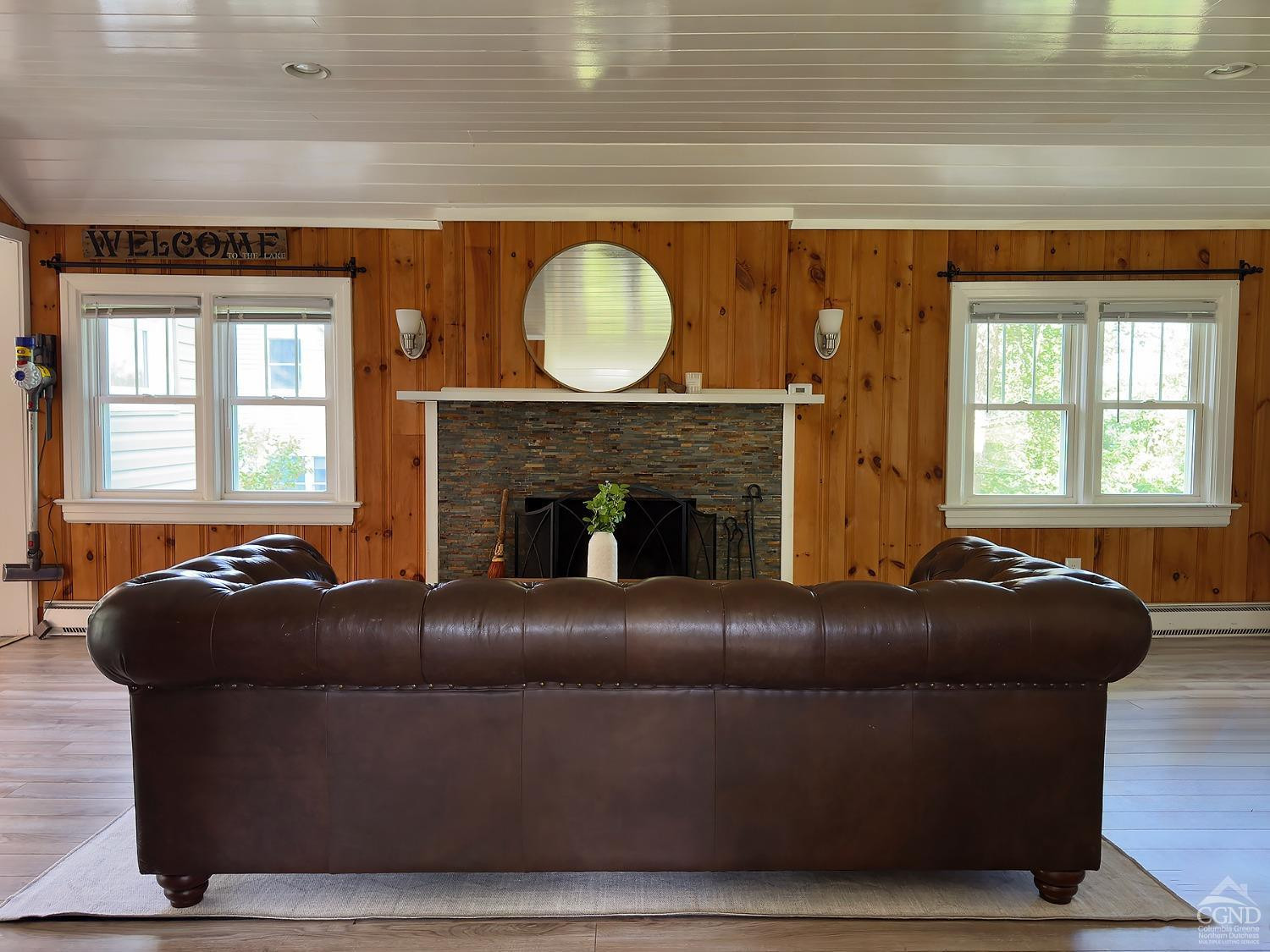 7 Pheasant Road Craryville, NY 12521 - Photo 8 of 26 a living room with a couch a fireplace a window and a potted plant