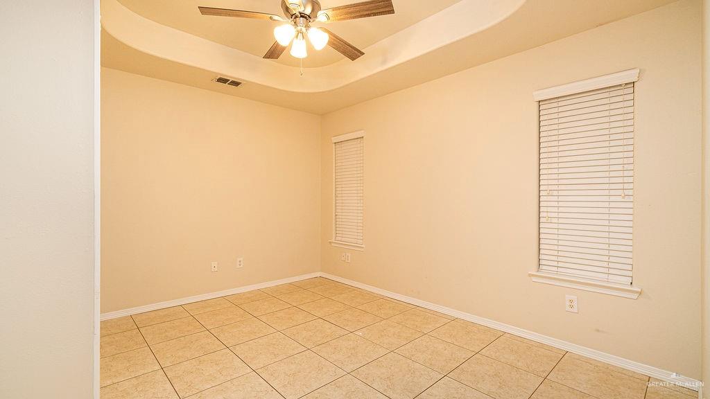 919 Hill Country Road Edinburg, TX 78539 - Photo 13 of 22 Room featuring tile flooring, a tray ceiling, and a ceiling fan with integrated lighting