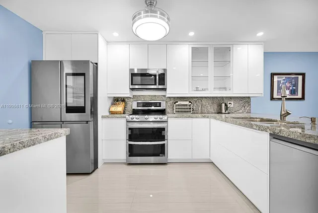 a kitchen with a sink stove and refrigerator