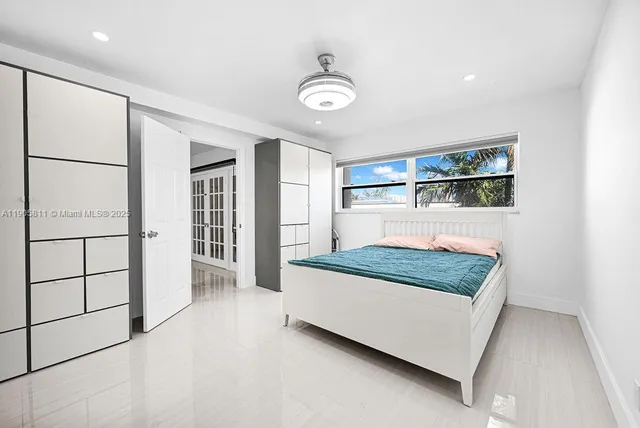a hallway with a large mirror and a dresser