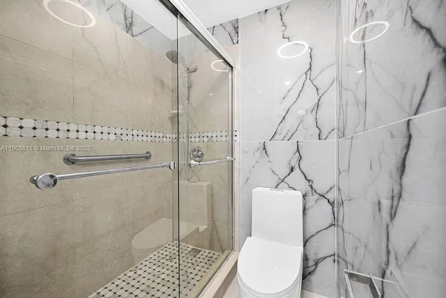 a bathroom with a toilet and shower