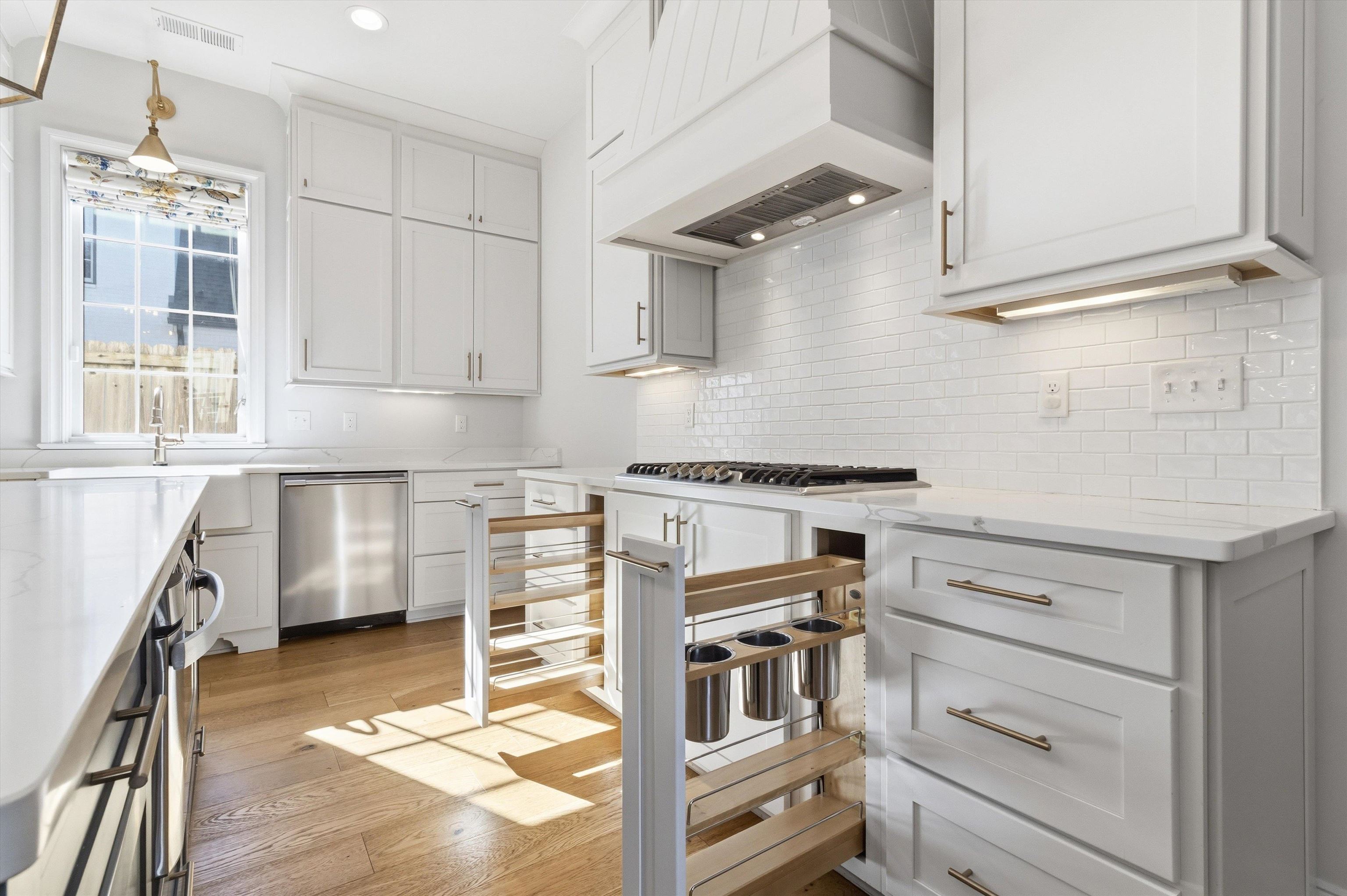 1111 Hayne Road Memphis, TN 38119 - Photo 13 of 40 Kitchen featuring light stone counters, white cabinets, stainless steel appliances, light wood-type flooring, and recessed lighting