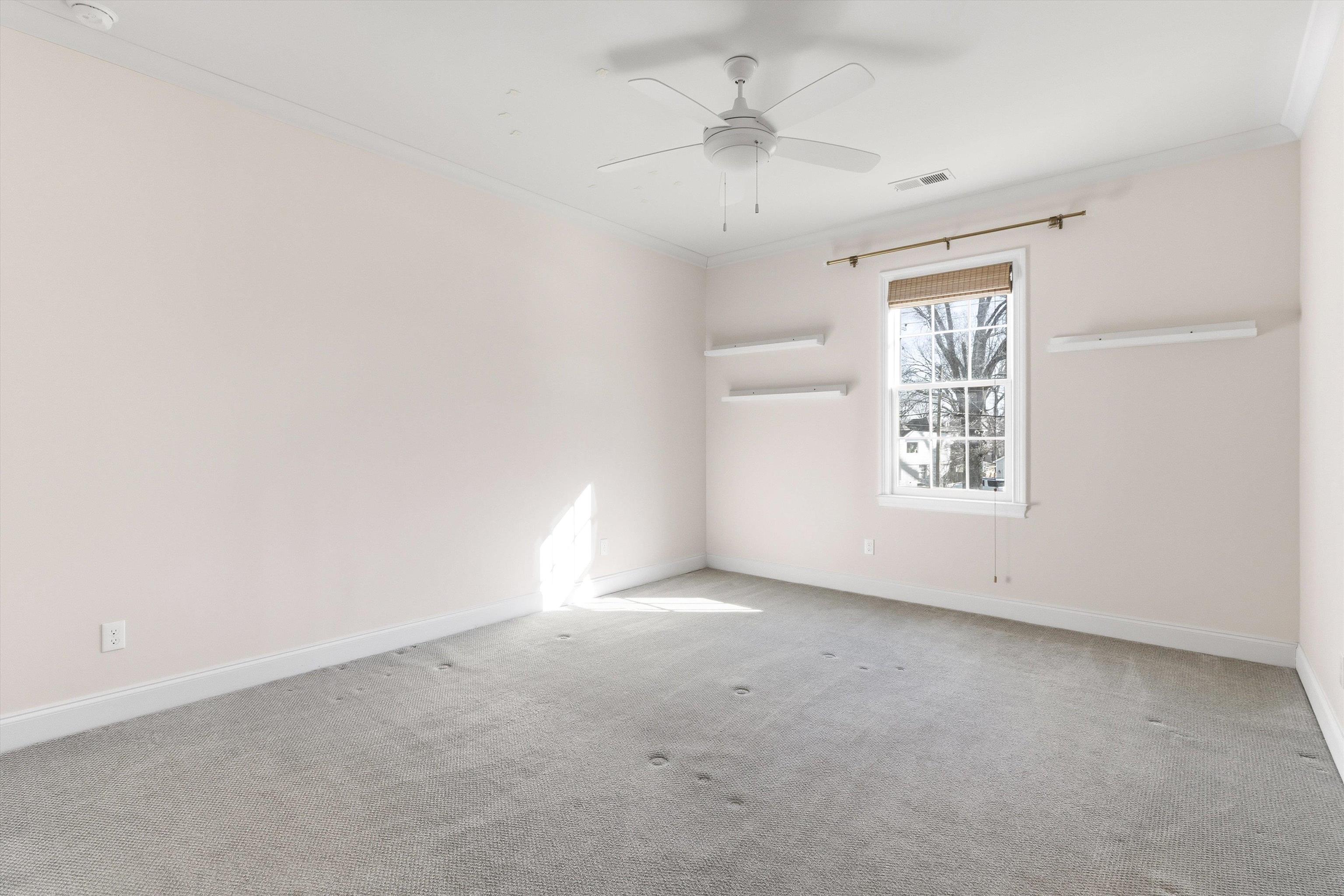1111 Hayne Road Memphis, TN 38119 - Photo 28 of 40 Carpeted spare room featuring crown molding and ceiling fan