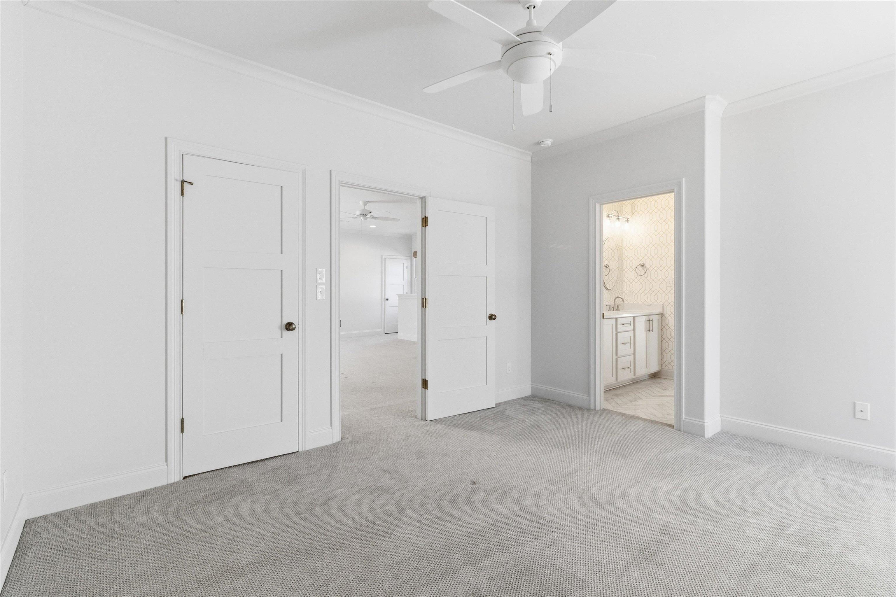 1111 Hayne Road Memphis, TN 38119 - Photo 33 of 40 Unfurnished bedroom with ornamental molding, light colored carpet, ceiling fan, and connected bathroom